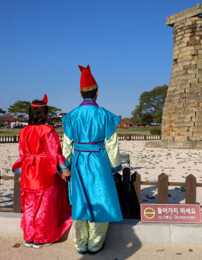 Cheomseongdae Observatory Tower with two people wearing traditional Korean dress © Visit Korea