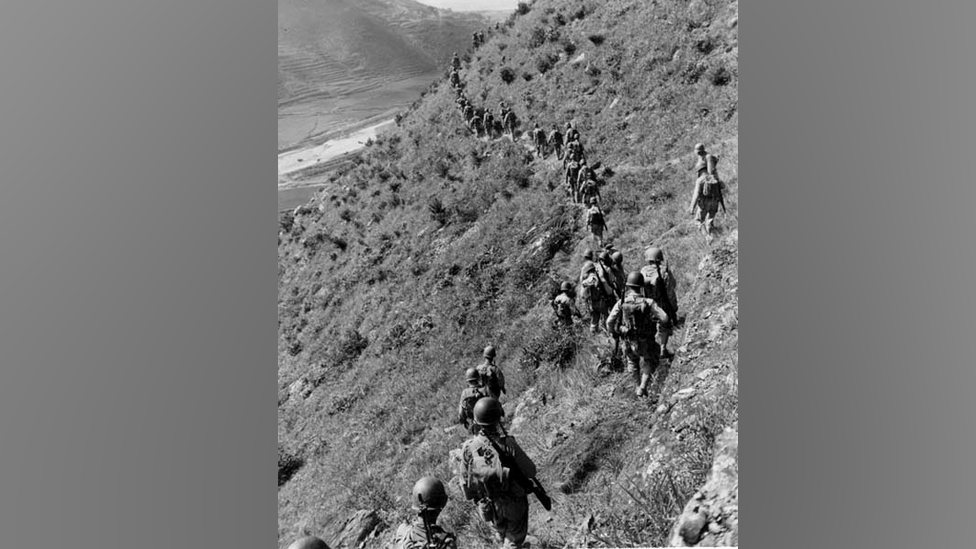 American soldiers advancing during the Korean War.